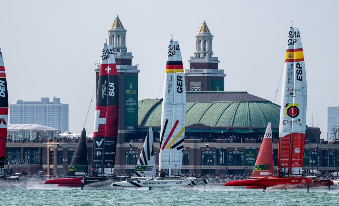 ROCKWOOL Denmark SailGP Team helmed by Nicolai Sehested leads Switzerland SailGP Team, Germany SailGP Team, Spain SailGP Team and Emirates Great Britain SailGP Team past Navy Pier on Race Day 1 of the Rolex United States Sail Grand Prix | Chicago at Navy Pier, Season 4, in Chicago, Illinois, USA. 16th June 2023. Photo: Bob Martin for SailGP. Handout image supplied by SailGP