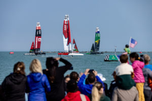 Canada SailGP Team helmed by Phil Robertson, ROCKWOOL Denmark SailGP Team helmed by Nicolai Sehested and Australia SailGP Team helmed by Tom Slingsby sail past the spectators in the SailGP Race Stadium on Race Day 1 of the Rolex United States Sail Grand Prix | Chicago at Navy Pier, Season 4, in Chicago, Illinois, USA. 16th June 2023. Photo: Katelyn Mulcahy for SailGP. Handout image supplied by SailGP